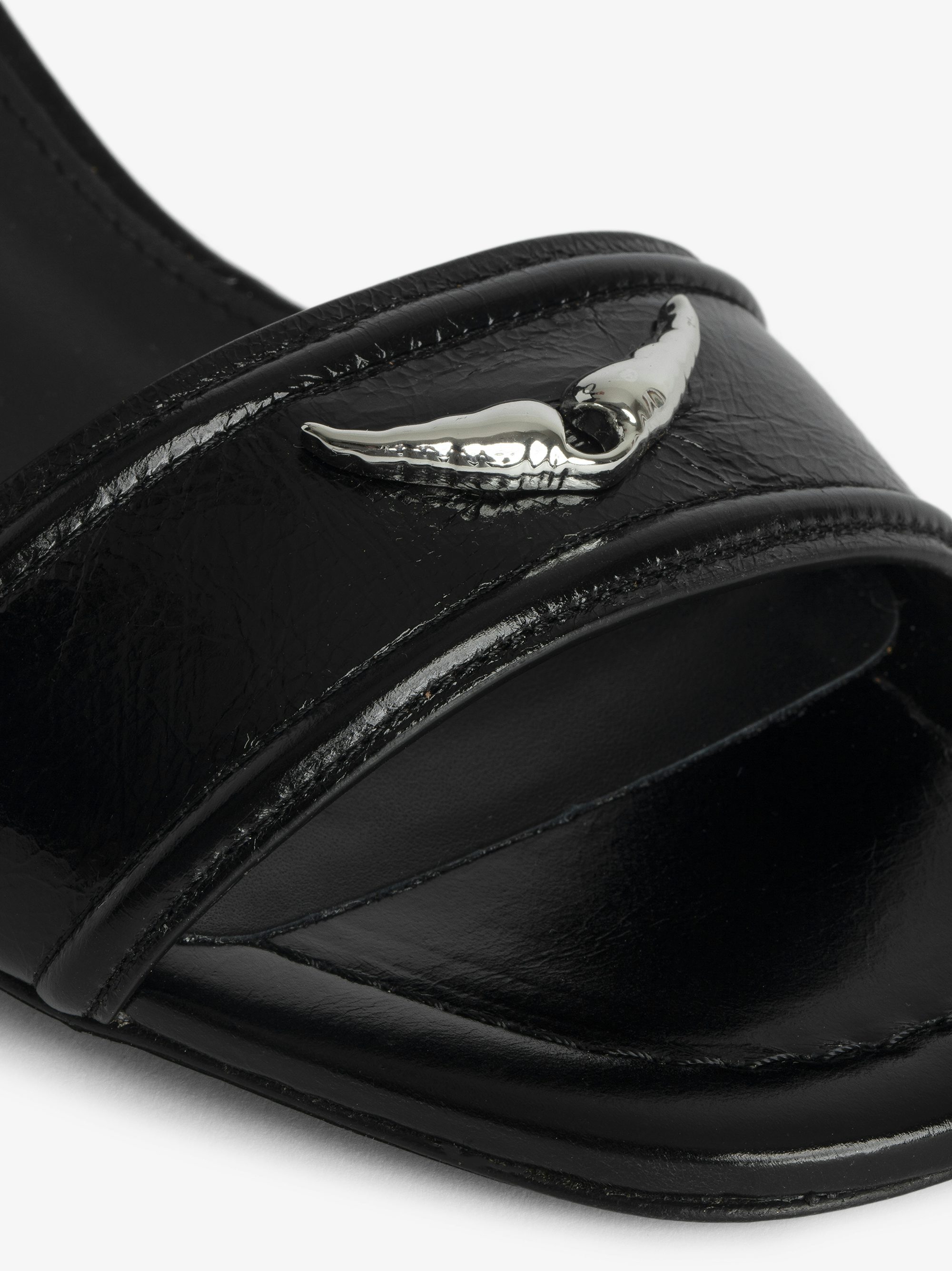 Caprese Sandals - Heeled sandals with leather strap adorned with a wing charm and a signature buckle.